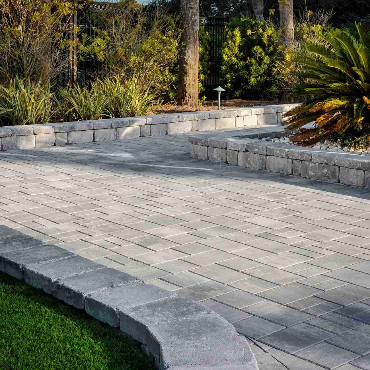 Paver patio with retaining wall border and landscape lighting