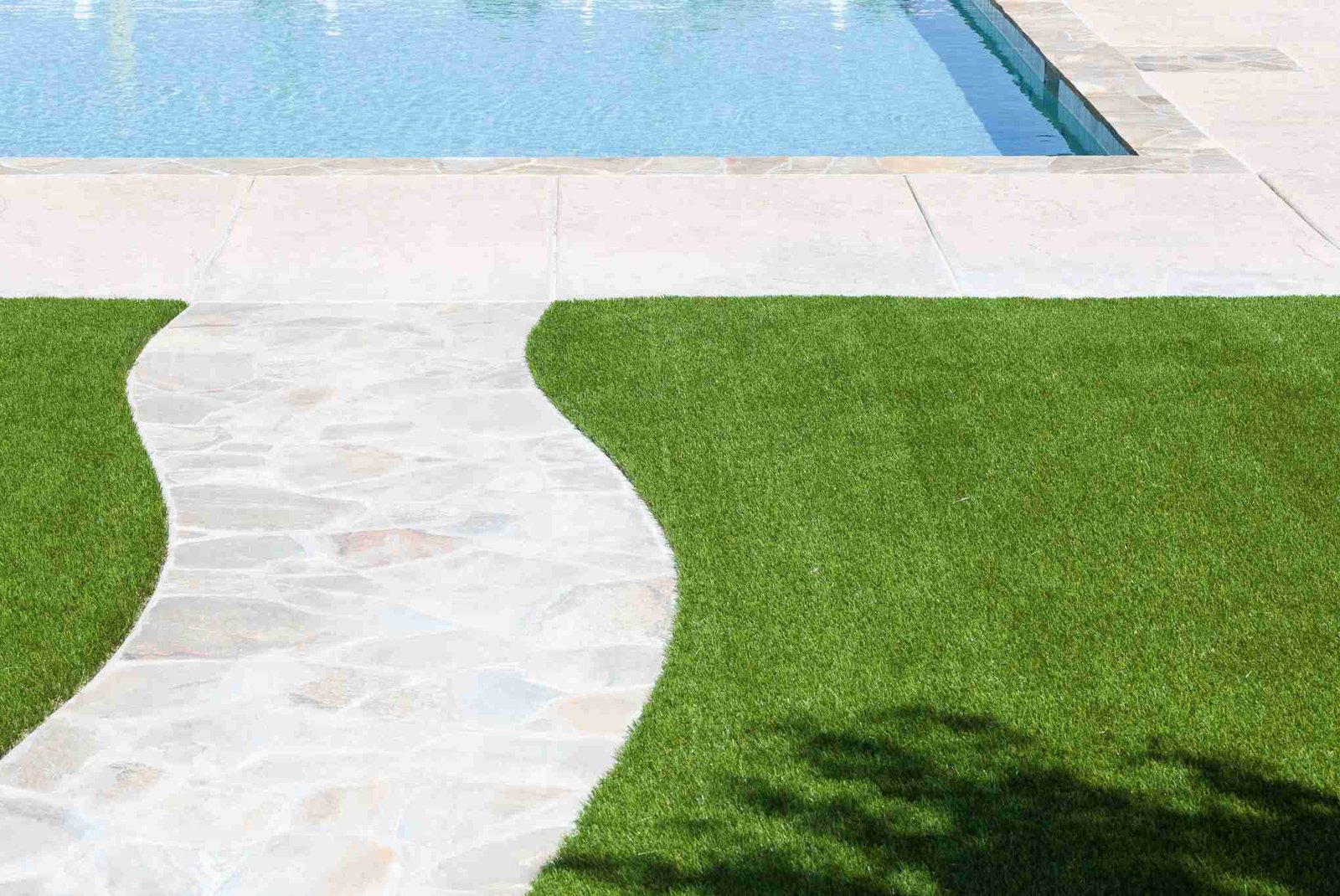 Artificial turf pool surround with stone paver walkway Jacksonville FL